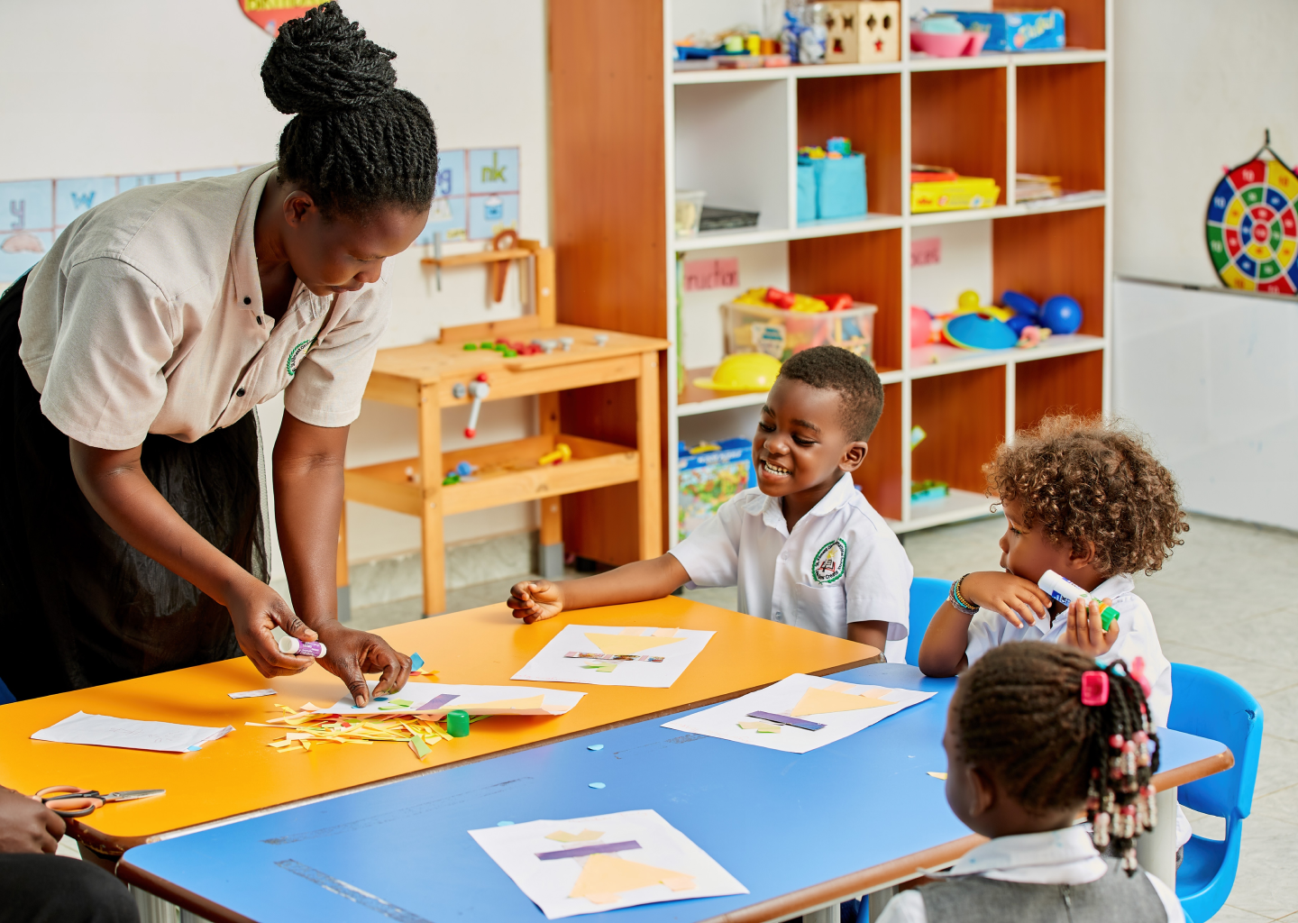Teacher assisting students with reading